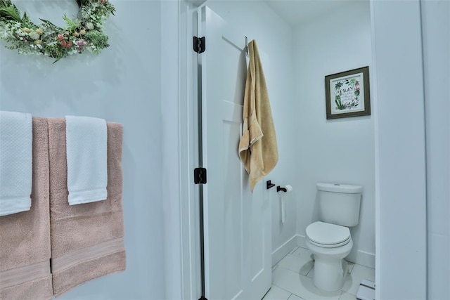 bathroom featuring toilet, a baseboard radiator, and baseboards