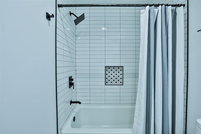 bathroom featuring toilet and shower / bathtub combination with curtain