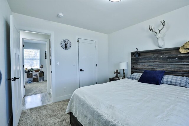 carpeted bedroom featuring baseboards