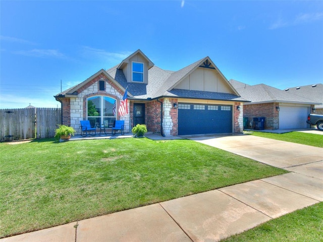 craftsman-style home featuring a garage, fence, driveway, and a front yard