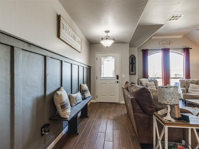 interior space with a healthy amount of sunlight, dark wood-style flooring, and visible vents
