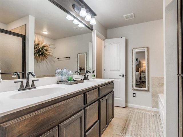 ensuite bathroom featuring tile patterned flooring, a sink, connected bathroom, and visible vents