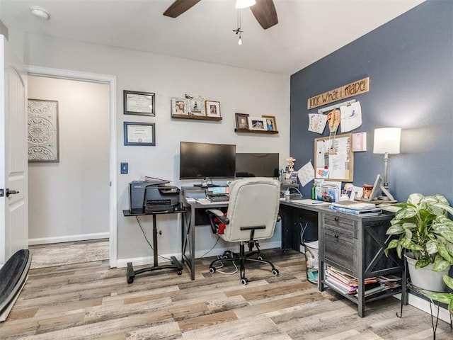 office area with baseboards, ceiling fan, and wood finished floors