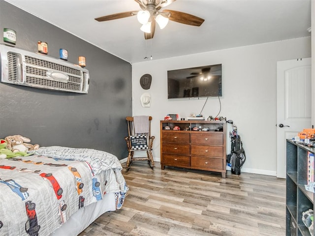 bedroom featuring baseboards, ceiling fan, and wood finished floors