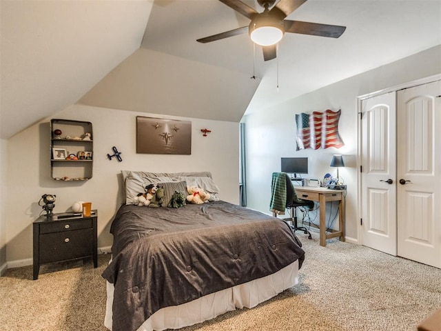 bedroom featuring a ceiling fan, carpet floors, baseboards, a closet, and lofted ceiling