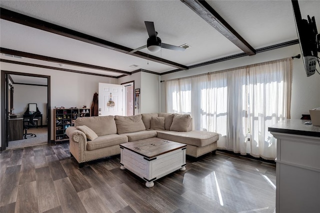 living room with ceiling fan, a textured ceiling, dark wood-type flooring, and beam ceiling