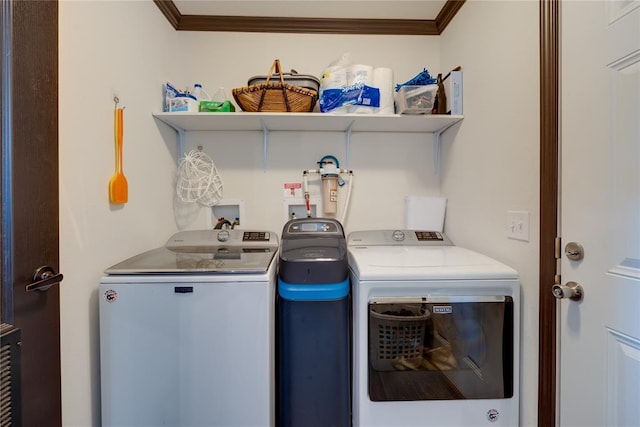 laundry area featuring washer and dryer, laundry area, and crown molding