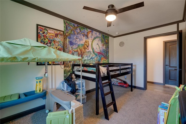 bedroom with carpet flooring, crown molding, and baseboards