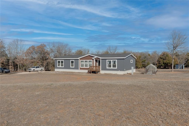 manufactured / mobile home featuring an outbuilding and an exterior structure