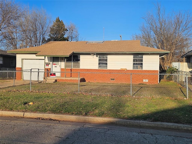 ranch-style home featuring a fenced front yard, brick siding, a front yard, crawl space, and a garage