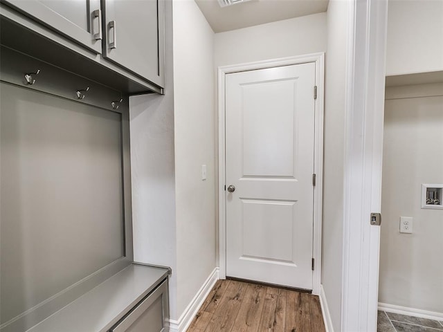 mudroom with baseboards, visible vents, and light wood finished floors