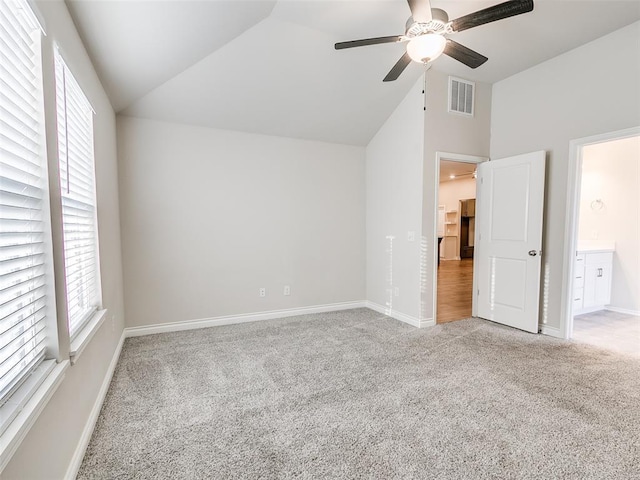 unfurnished bedroom with vaulted ceiling, carpet, visible vents, and baseboards