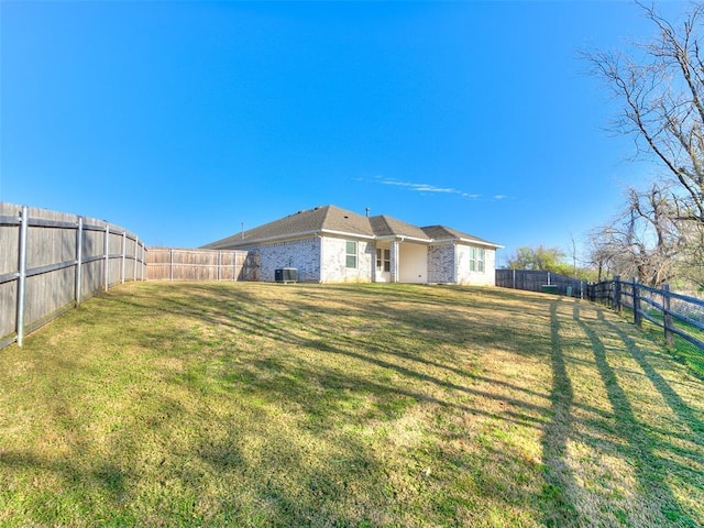 view of yard featuring a fenced backyard and central AC unit