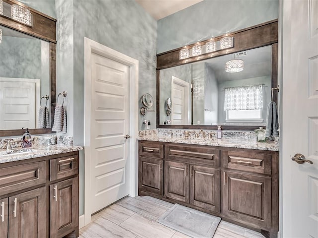 bathroom featuring two vanities and a sink