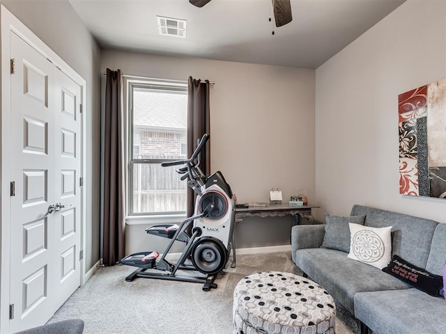 workout area featuring baseboards, carpet, visible vents, and a ceiling fan