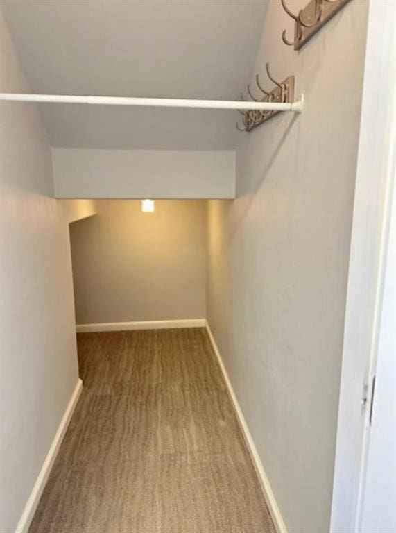 18816 Havenbrook Rd, Edmond, OK 73012 - walk in closet featuring carpet floors and vaulted ceiling