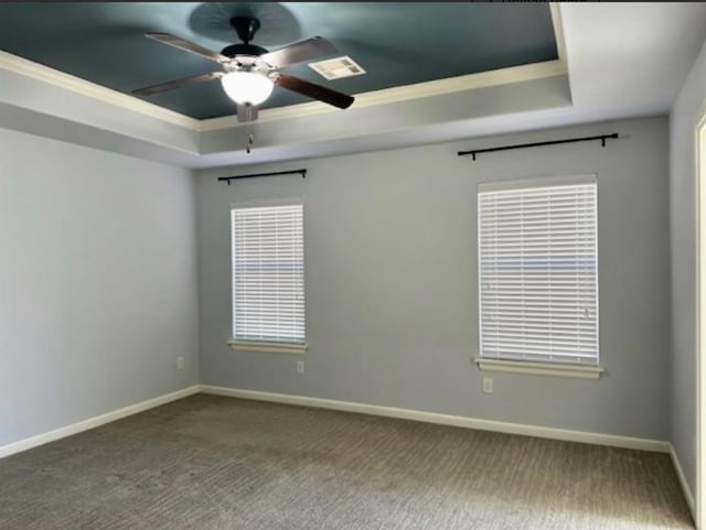 18816 Havenbrook Rd, Edmond, OK 73012 - carpeted empty room with a tray ceiling, crown molding, a ceiling fan, and baseboards