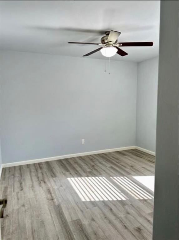 18816 Havenbrook Rd, Edmond, OK 73012 - spare room with wood finished floors, ceiling fan, and baseboards
