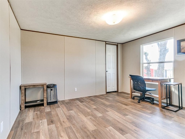 office featuring light wood-style floors, crown molding, and a textured ceiling