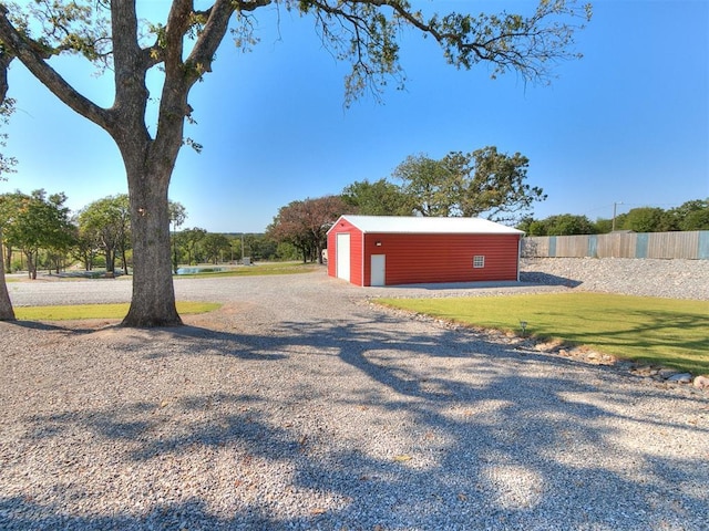 view of yard featuring an outbuilding and a garage