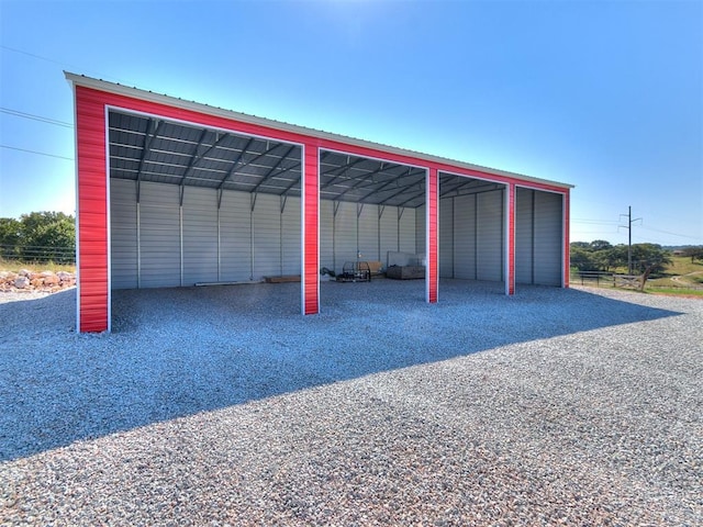 garage featuring a carport and driveway