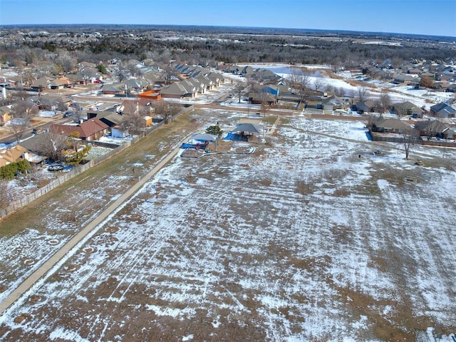 snowy aerial view with a residential view