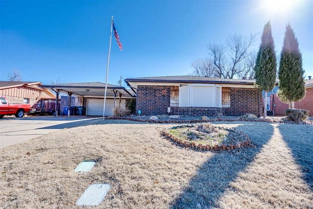 ranch-style home featuring a garage, driveway, brick siding, and a carport