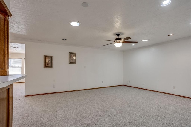 carpeted spare room with ceiling fan, baseboards, a textured ceiling, and recessed lighting