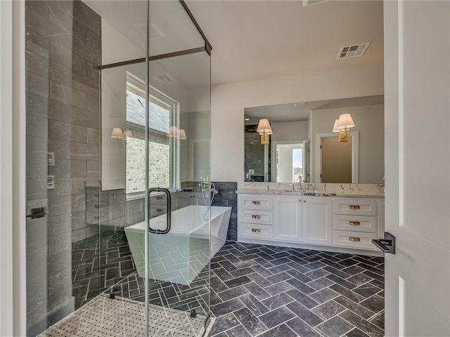 bathroom featuring a soaking tub, vanity, visible vents, and a shower stall