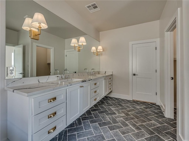 full bathroom featuring double vanity, baseboards, visible vents, and a sink