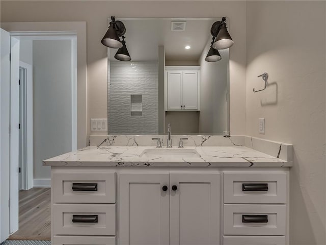 bathroom with recessed lighting, visible vents, wood finished floors, and vanity