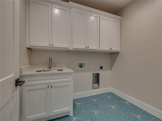 laundry area featuring cabinet space, baseboards, a sink, hookup for a washing machine, and electric dryer hookup