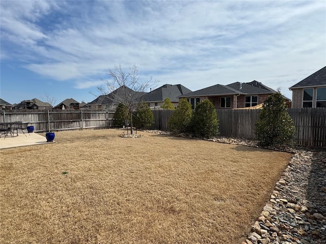 view of yard with a fenced backyard and a patio