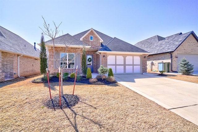 view of front facade with brick siding, driveway, and a garage