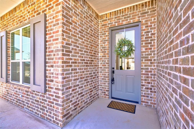 property entrance with brick siding