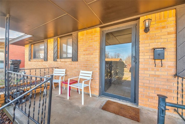 property entrance featuring brick siding