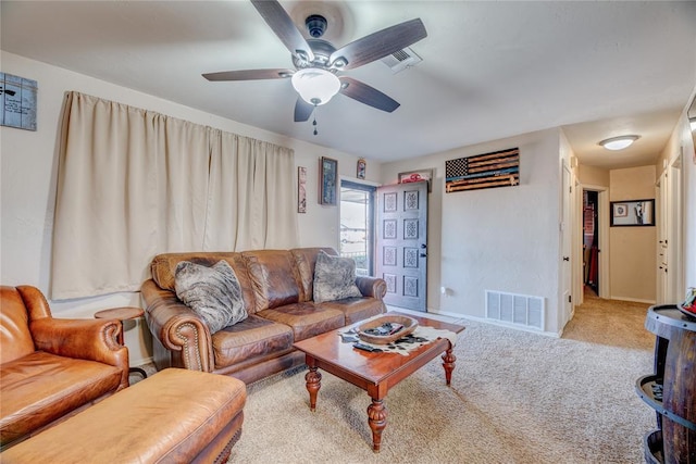 living room with a ceiling fan, carpet, visible vents, and baseboards