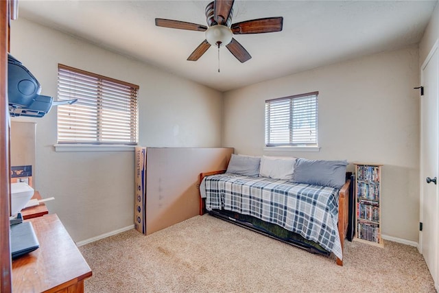 carpeted bedroom featuring ceiling fan and baseboards