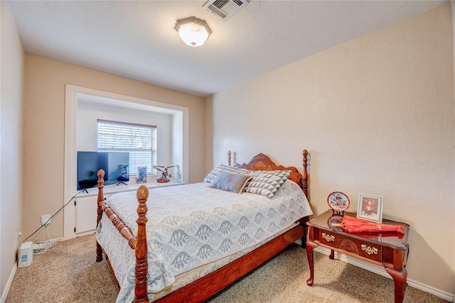 carpeted bedroom with visible vents and baseboards