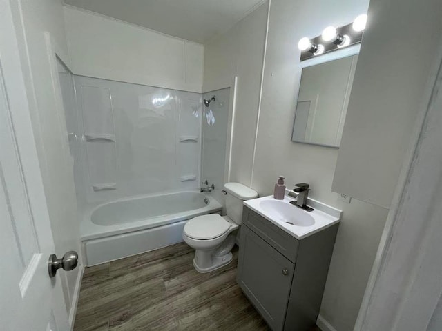 bathroom featuring  shower combination, vanity, toilet, and wood finished floors