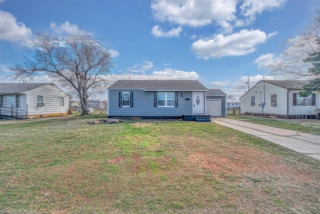 view of front of home featuring a garage, a front yard, and driveway