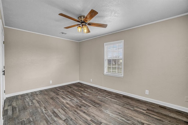 empty room featuring dark wood-type flooring, ornamental molding, and baseboards