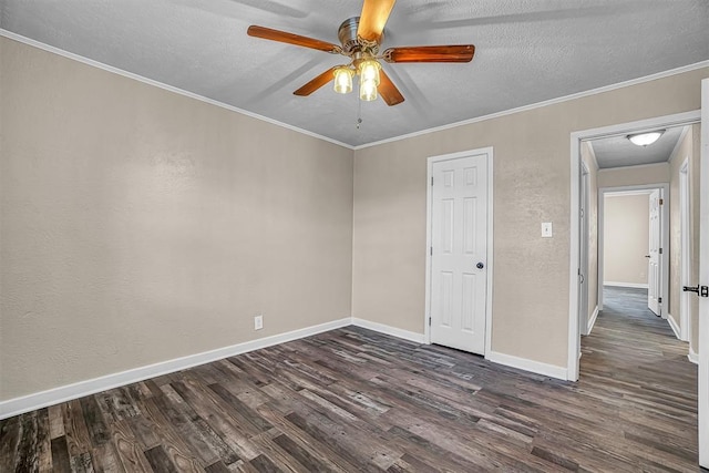 spare room with dark wood-style flooring, ornamental molding, ceiling fan, a textured ceiling, and baseboards