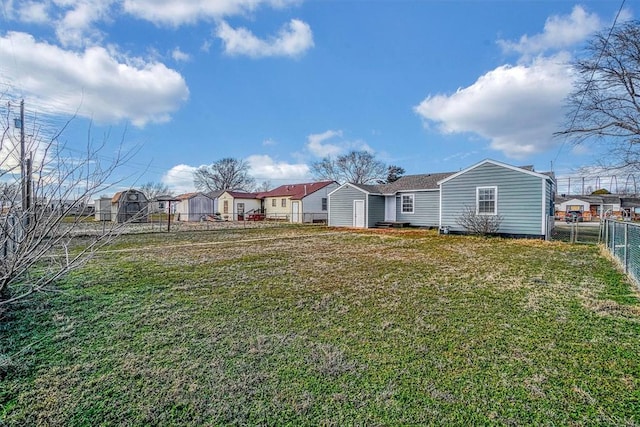 view of yard featuring a residential view and fence