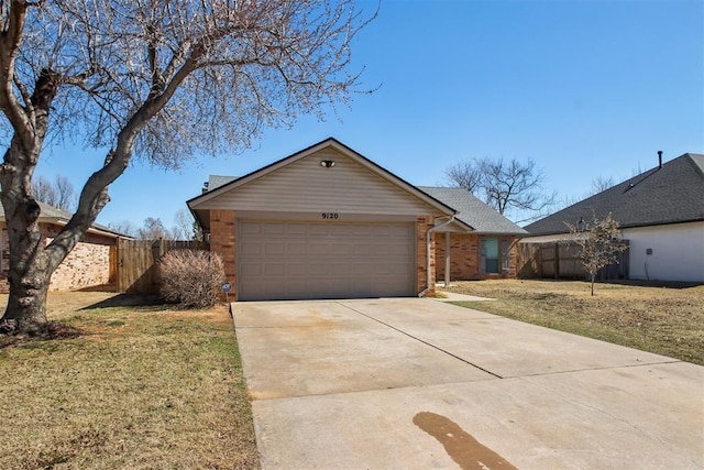 view of front of home featuring an attached garage, brick siding, fence, driveway, and a front yard