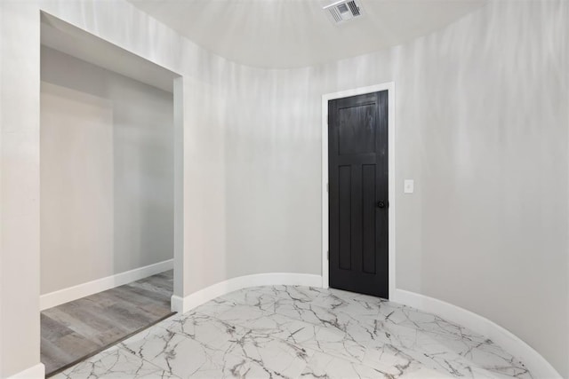 bedroom featuring marble finish floor, visible vents, and baseboards