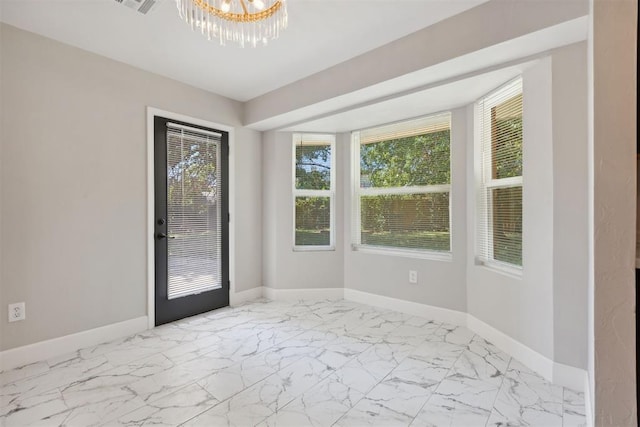 doorway to outside with baseboards, marble finish floor, and an inviting chandelier