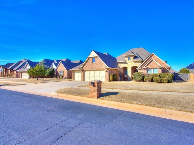 view of front of house featuring an attached garage, brick siding, fence, concrete driveway, and a residential view