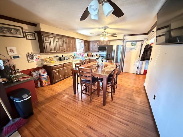 505 SE 18th St, Oklahoma City, OK 73129 - dining area with ornamental molding and light wood-style floors