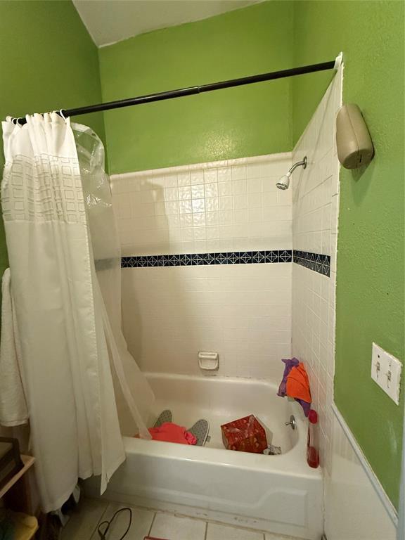 505 SE 18th St, Oklahoma City, OK 73129 - full bathroom featuring tile patterned flooring and shower / tub combo with curtain
